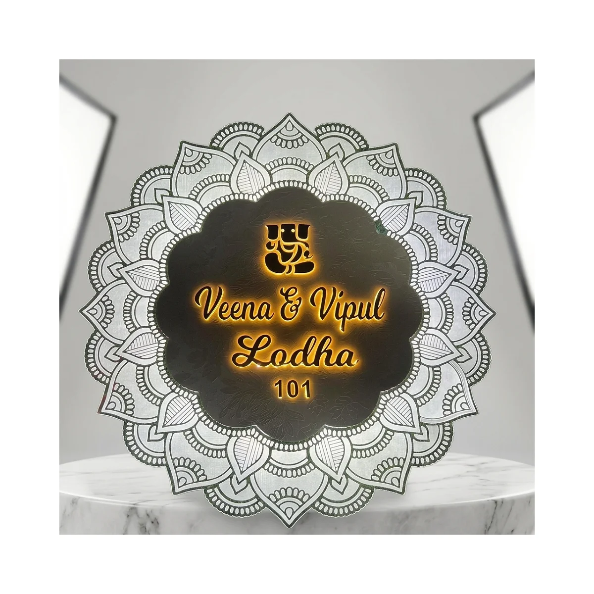 Ganesh Mandala: A dark floral centre with gold-tone names and an engraved-style mandala border.