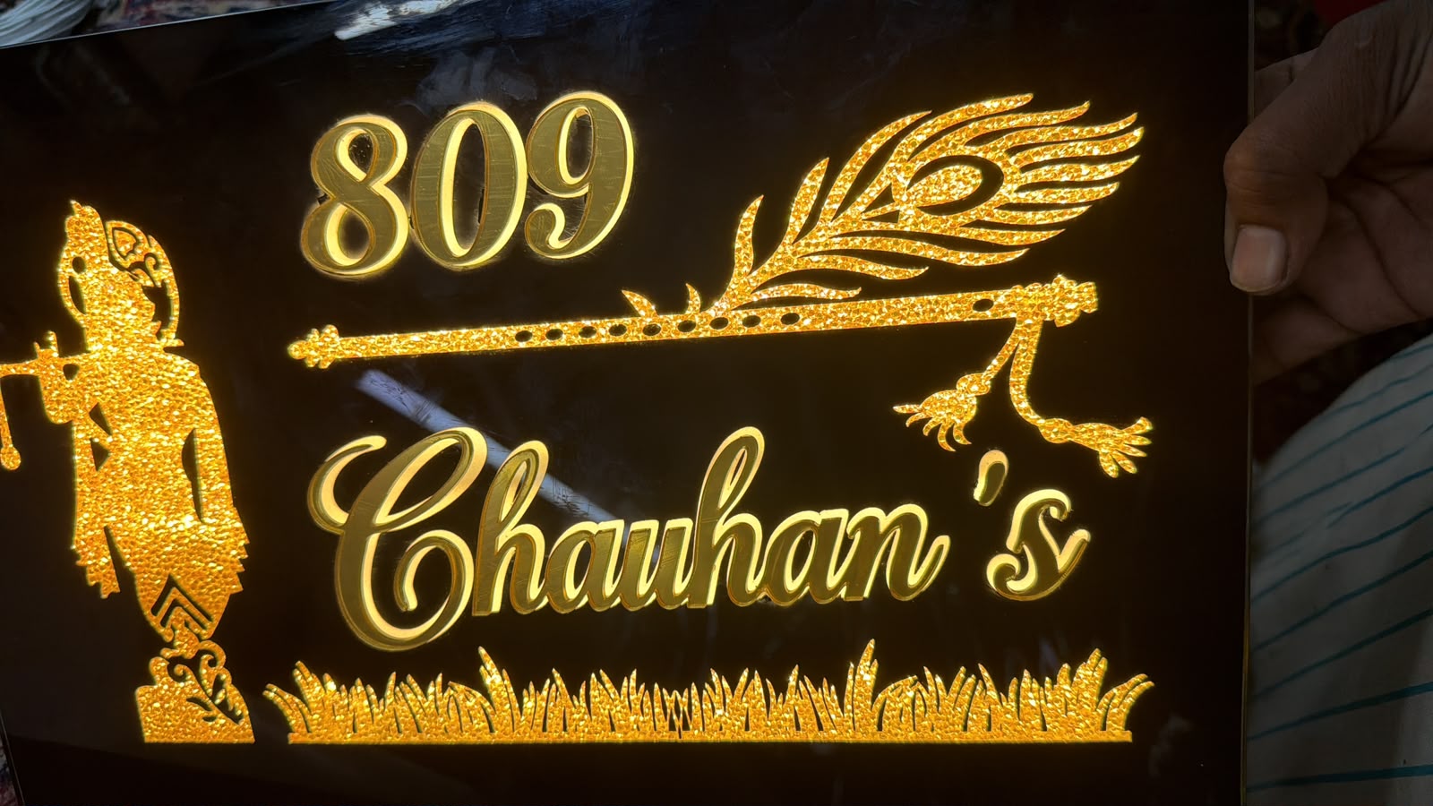 Original workshop photograph of an illuminated acrylic nameplate made by Name It Studio
